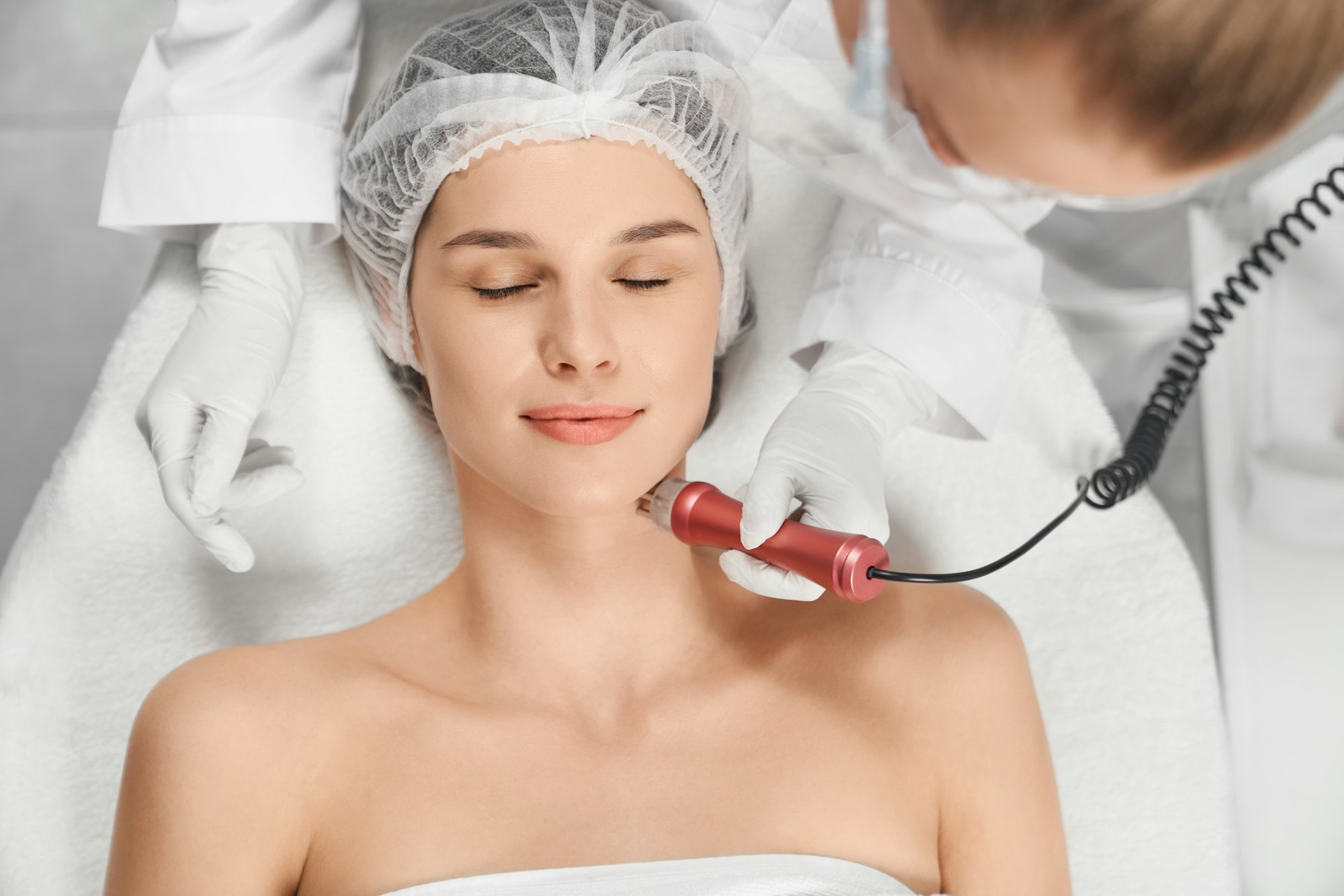 Woman enjoying procedure cleaning or massage for face